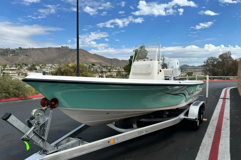 Slide: The Image of 2020 Blue Wave 2000 Classic boat interior with white seating and storage compartments. - 5