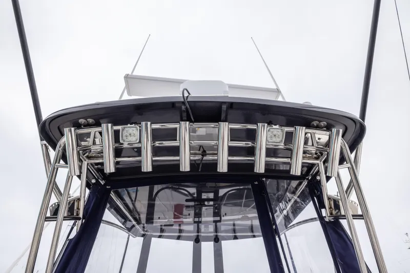 Slide: The Image of 2023 Skipjack 26 Flybridge boat with stainless steel railings and clear canopy. - 12