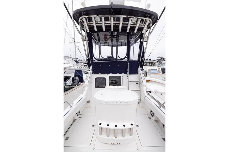 Slide: The Image of 2023 Skipjack 26 Flybridge boat interior with seating and fishing rod holders. - 14