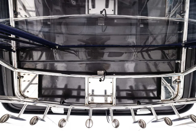 Slide: The Image of 2023 Skipjack 26 Flybridge boat deck with stainless steel railings and rod holders. - 16