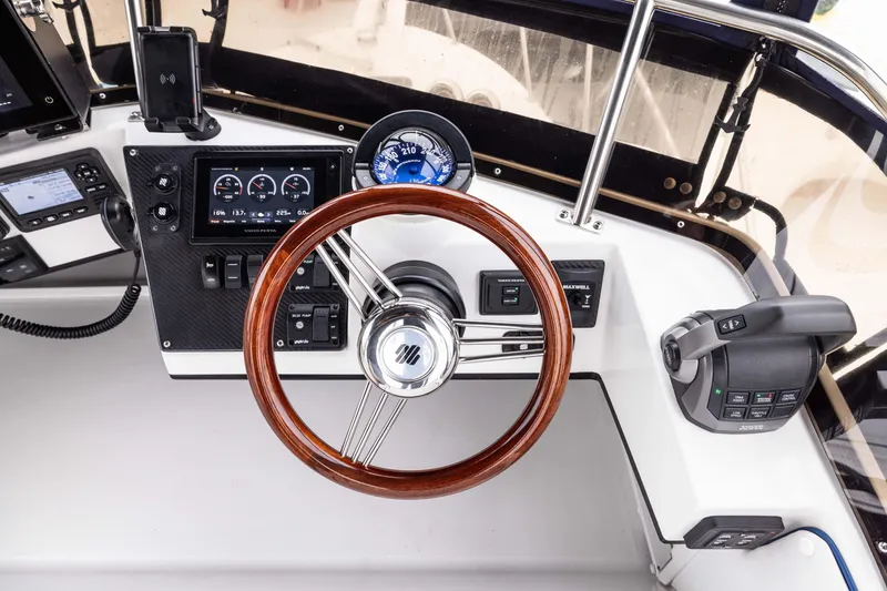 Slide: The Image of Steering wheel and controls of 2023 Skipjack 26 Flybridge boat cockpit. - 20