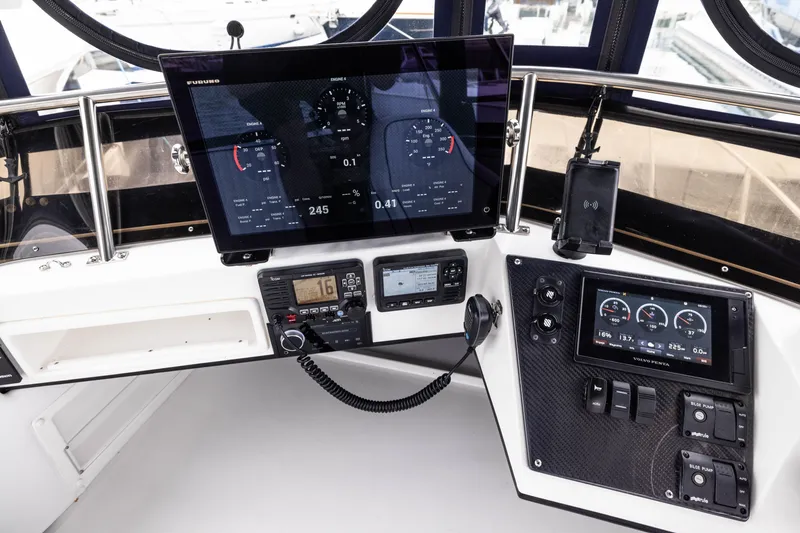 Slide: The Image of 2023 Skipjack 26 Flybridge helm with advanced navigation and control systems. - 21