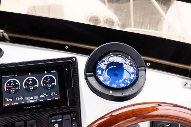 Slide: The Image of Skipjack 26 Flybridge 2023 dashboard with compass and Volvo Penta display. - 23