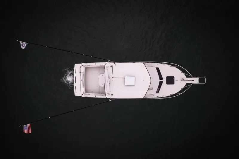 Slide: The Image of Aerial view of 2023 Skipjack 26 Flybridge boat on dark water. - 5