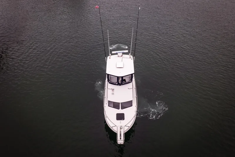 Slide: The Image of Aerial view of 2023 Skipjack 26 Flybridge boat cruising on water. - 7