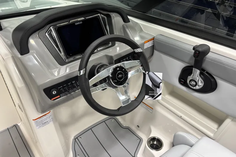 Slide: The Image of 2026 Chaparral 23 SSi boat dashboard with steering wheel and control panel. - 15