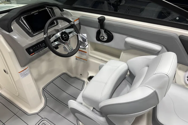 Slide: The Image of 2026 Chaparral 23 SSi boat interior with steering wheel and captain's seat. - 16