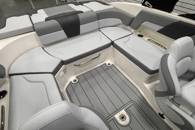Slide: The Image of 2026 Chaparral 23 SSi boat interior with gray seating and flooring, showcasing modern design. - 20
