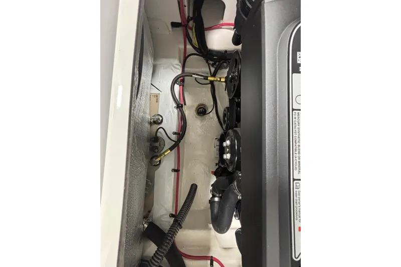 Slide: The Image of Engine compartment of 2026 Chaparral 23 SSi boat, showcasing wiring and components. - 24