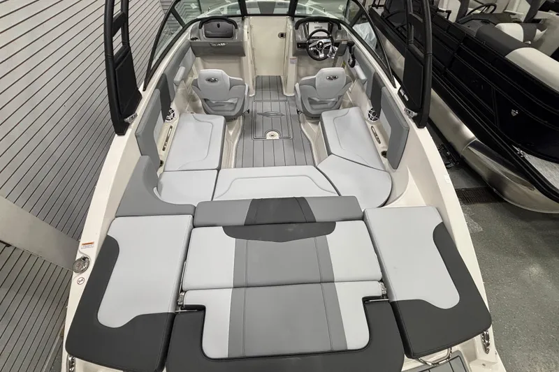 Slide: The Image of 2026 Chaparral 23 SSi boat interior with gray seating and modern design. - 27