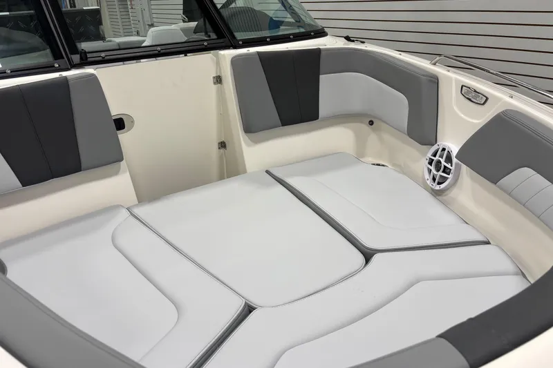 Slide: The Image of 2026 Chaparral 23 SSi boat interior with gray and white cushioned seating. - 31
