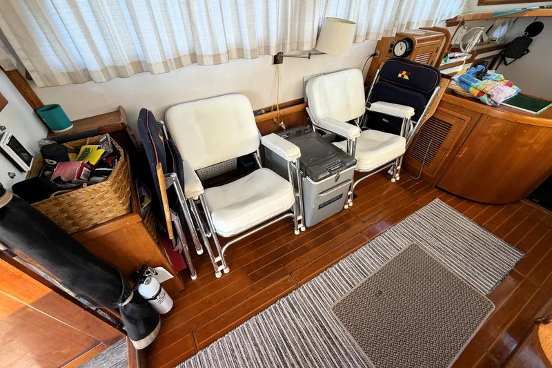 Slide: The Image of Interior of 1983 Wilbur 34 Fly Bridge Cruiser with chairs and wooden flooring. - 13