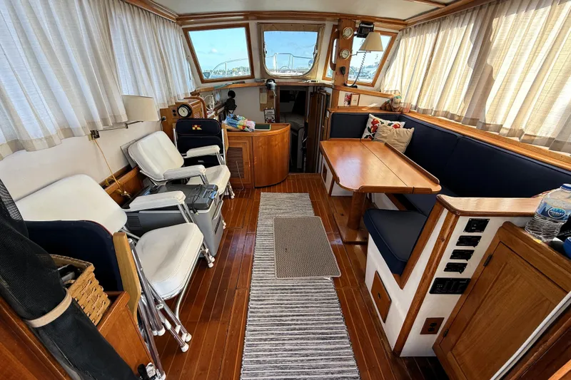 Slide: The Image of Interior of 1983 Wilbur 34 Fly Bridge Cruiser with wooden furnishings and seating. - 2
