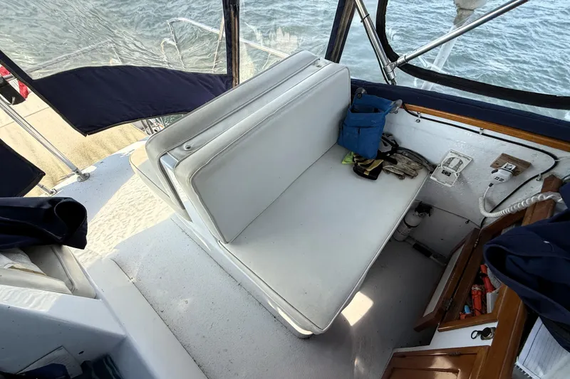 Slide: The Image of Interior of 1983 Wilbur 34 Fly Bridge Cruiser with white seating and nautical equipment. - 28