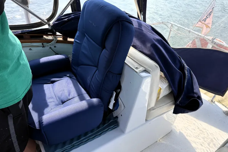 Slide: The Image of Blue captain's chair on 1983 Wilbur 34 Fly Bridge Cruiser, with ocean view. - 29