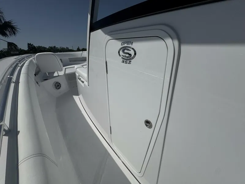 Slide: The Image of 2025 Sportsman 352 Open boat, sleek white design, side view with seating area. - 21