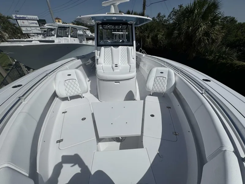 Slide: The Image of 2025 Sportsman 352 Open boat with white seating and table, docked at Thunder Marine. - 25