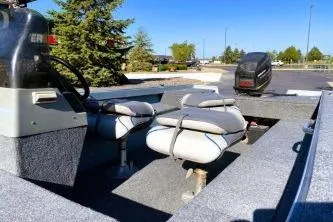 Slide: The Image of 1995 Tracker Pro Deep V-17 boat with seating and motor, parked outdoors. - 6