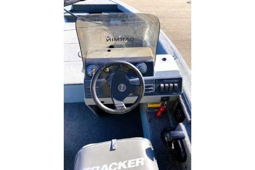 Slide: The Image of 1995 Tracker Pro Deep V-17 boat dashboard with steering wheel and controls. - 7