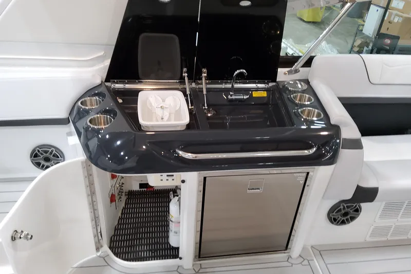 Slide: The Image of 2026 Formula 350 Crossover Bowrider OB boat kitchenette with sink, faucet, and storage. - 30