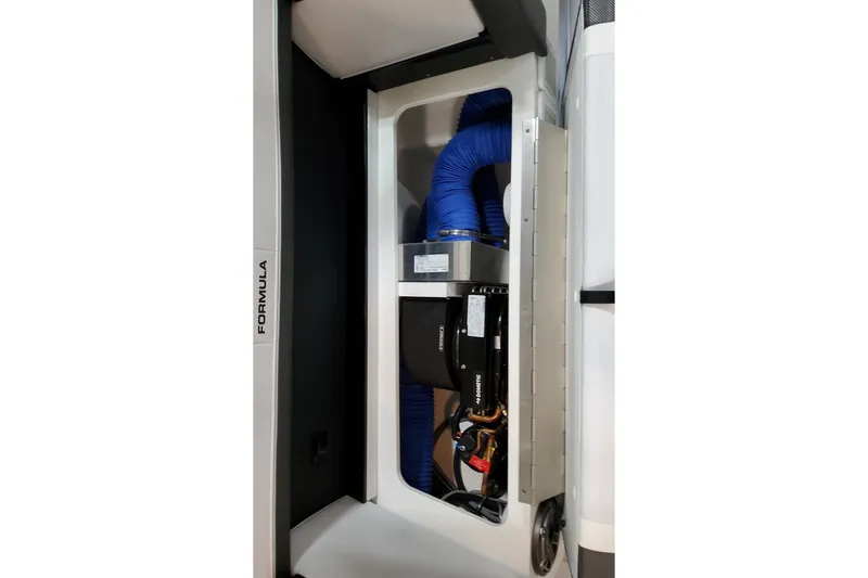 Slide: The Image of 2026 Formula 350 Crossover Bowrider OB engine compartment with blue hoses and mechanical components. - 33