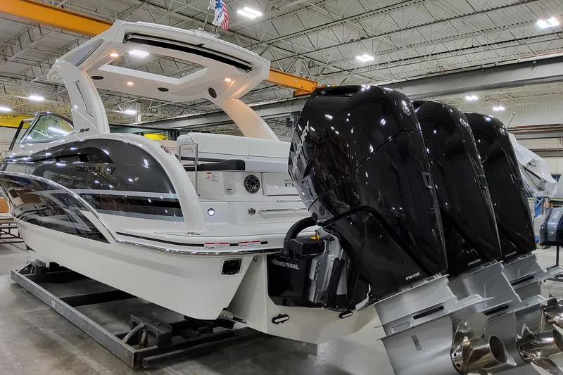 Slide: The Image of 2026 Formula 350 Crossover Bowrider OB with triple outboard engines in a showroom. - 4