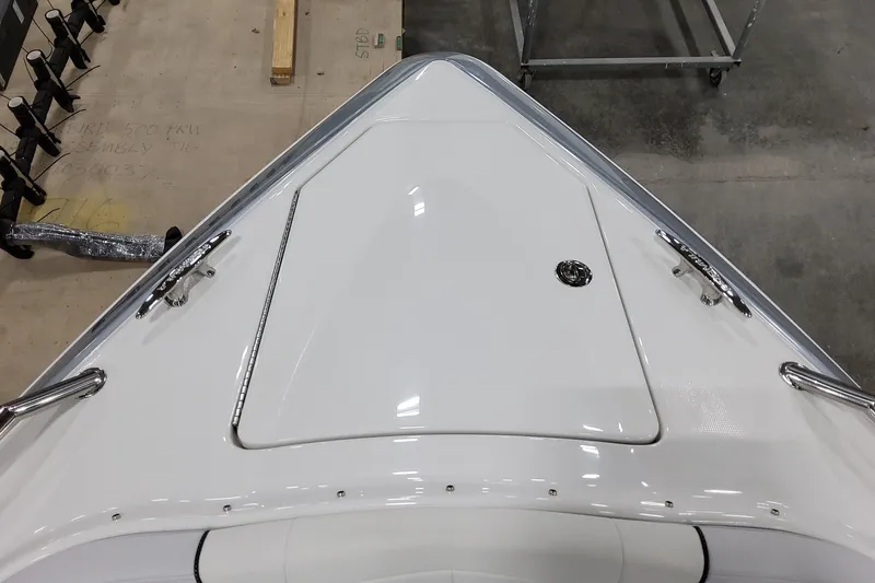 Slide: The Image of 2026 Formula 350 Crossover Bowrider OB, sleek white bow design, docked indoors. - 48