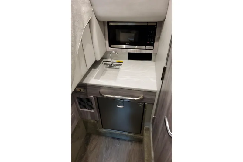 Slide: The Image of Compact kitchenette in 2026 Formula 350 Crossover Bowrider OB with sink, microwave, and fridge. - 56