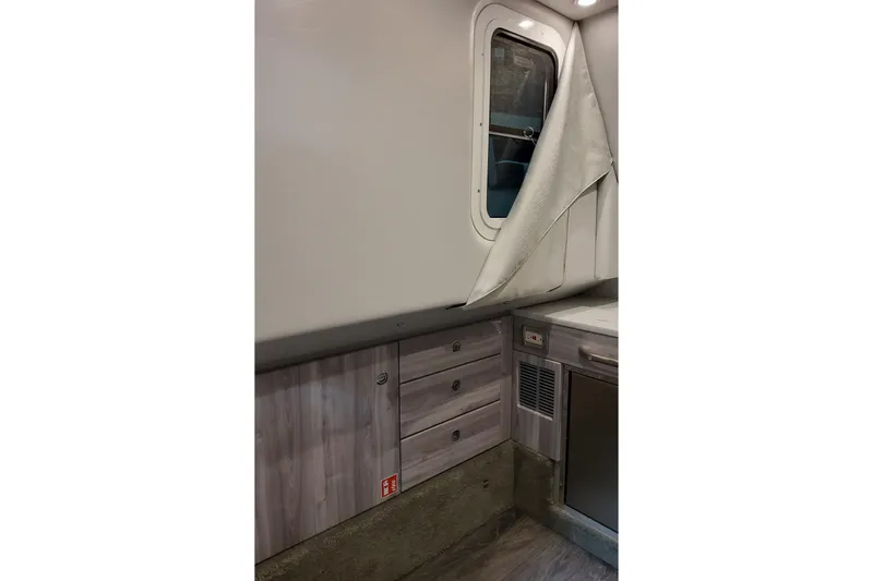 Slide: The Image of 2026 Formula 350 Crossover Bowrider OB interior with wood cabinets and window. - 57