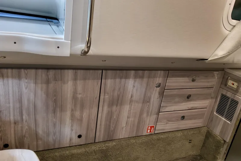 Slide: The Image of Interior view of 2026 Formula 350 Crossover Bowrider OB with wood paneling and storage compartments. - 58