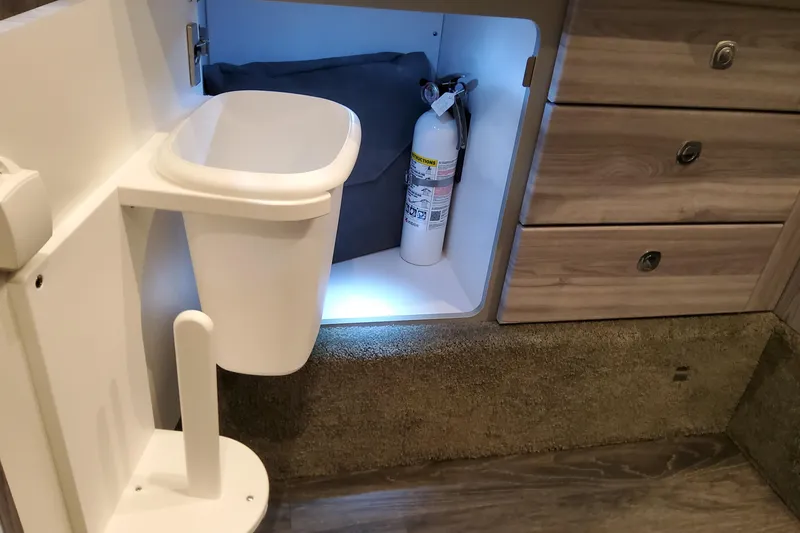 Slide: The Image of Interior of 2026 Formula 350 Crossover Bowrider OB with storage and fire extinguisher. - 59