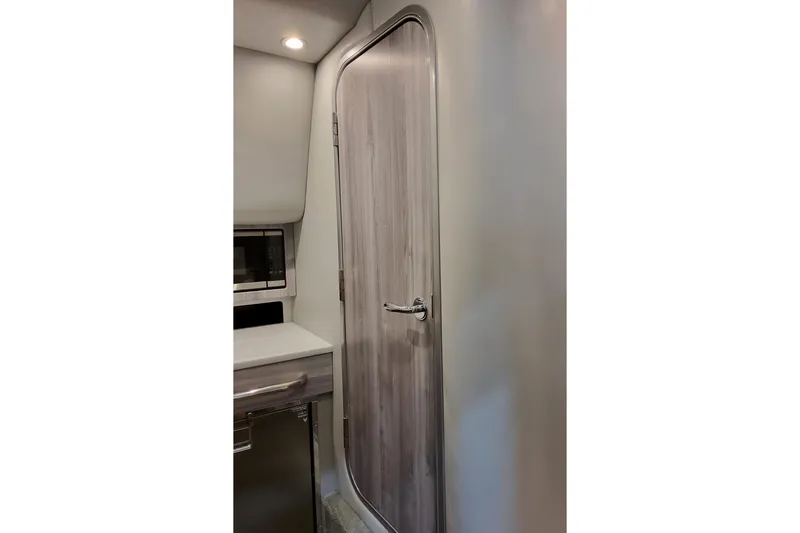 Slide: The Image of Interior of 2026 Formula 350 Crossover Bowrider OB, featuring sleek wooden door and modern cabinetry. - 60