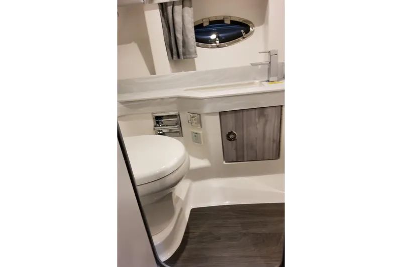 Slide: The Image of 2026 Formula 350 Crossover Bowrider OB bathroom with modern fixtures and wood accents. - 62