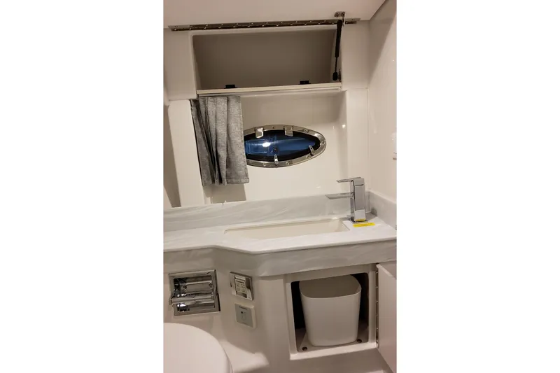 Slide: The Image of Bathroom interior of 2026 Formula 350 Crossover Bowrider OB with sink and porthole window. - 64