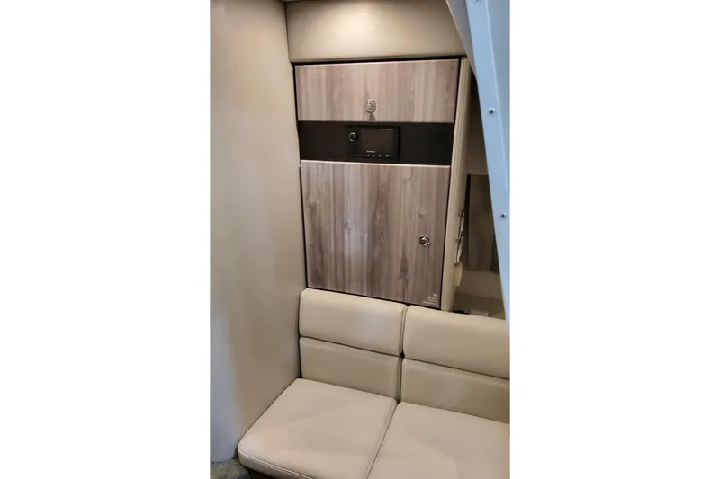 Slide: The Image of 2026 Formula 350 Crossover Bowrider OB interior with wood paneling and beige seating. - 65