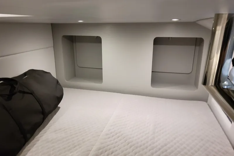 Slide: The Image of 2026 Formula 350 Crossover Bowrider OB cabin interior with storage compartments and bedding. - 70