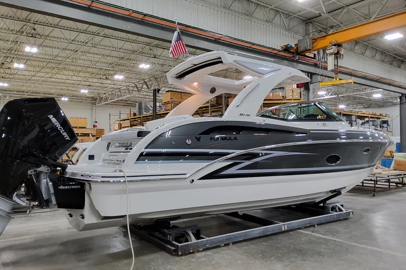 Slide: The Image of 2026 Formula 350 Crossover Bowrider OB in a warehouse, showcasing sleek design and powerful outboard engine. - 8