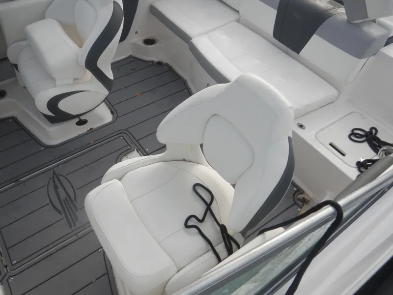 Slide: The Image of 2023 Chaparral 21 SSi OB boat interior with white seating and gray flooring. - 12