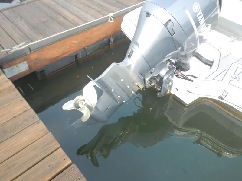 Slide: The Image of 2023 Chaparral 21 SSi OB boat with Yamaha outboard motor at dock. - 2