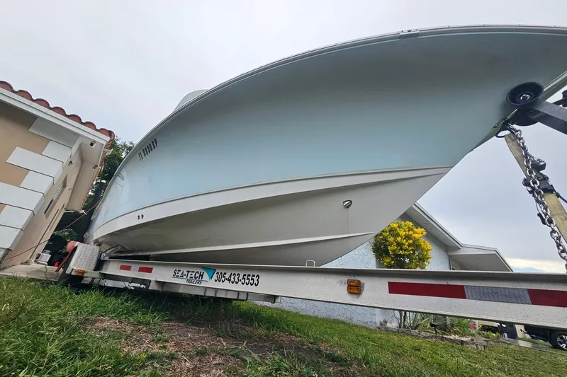 Slide: The Image of 2020 Sea Hunt BX 25 FS boat on trailer, parked beside a house. - 3