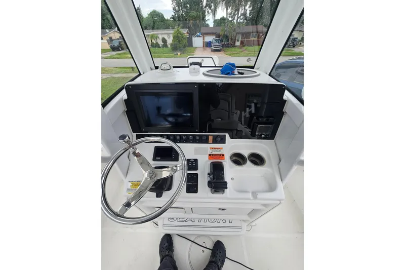 Slide: The Image of 2020 Sea Hunt BX 25 FS boat console with steering wheel and controls. - 6