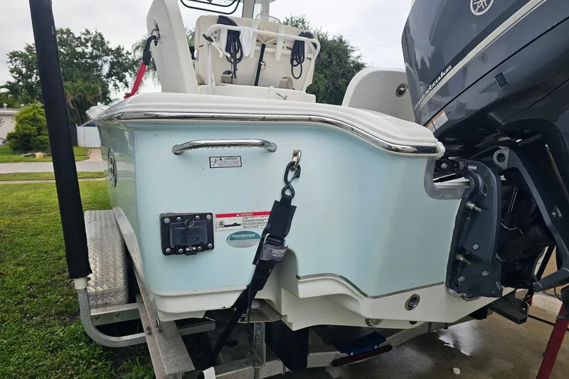 Slide: The Image of 2020 Sea Hunt BX 25 FS boat on trailer, featuring outboard motor and sleek design. - 8