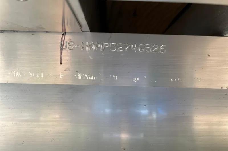 Slide: The Image of 2025 Harris Sunliner 250 hull identification number engraved on metal surface. - 13