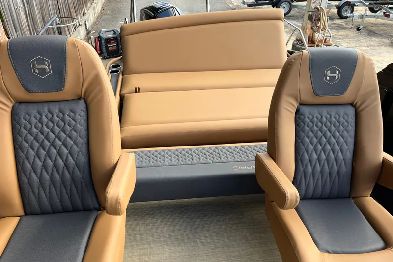 Slide: The Image of 2025 Harris Sunliner 250 boat interior with tan and gray seating, featuring diamond stitching. - 4