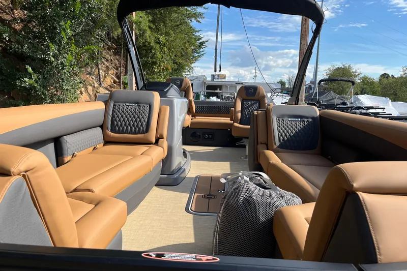 Slide: The Image of 2025 Harris Sunliner 250 boat interior with luxurious tan seating and modern design. - 6