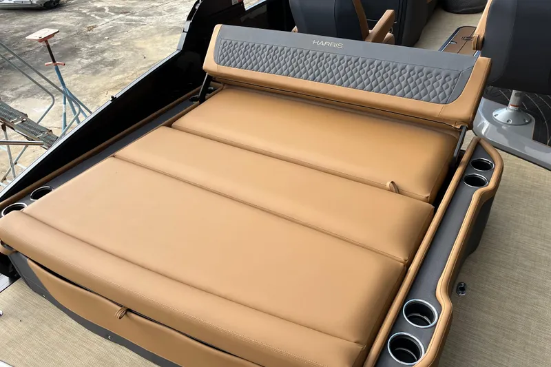 Slide: The Image of Luxurious seating on 2025 Harris Sunliner 250 boat with tan upholstery and cup holders. - 7