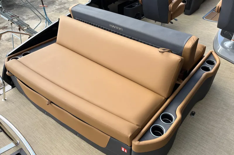Slide: The Image of 2025 Harris Sunliner 250 boat interior with tan seating and cup holders. - 8