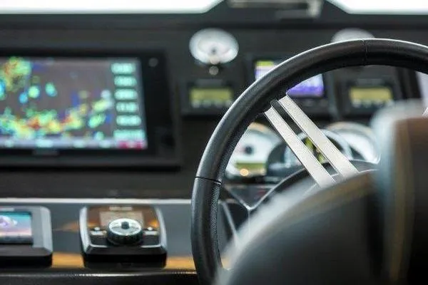Slide: The Image of Steering wheel and dashboard of 2021 OKEAN FB Motor Yacht with navigation screens. - 14