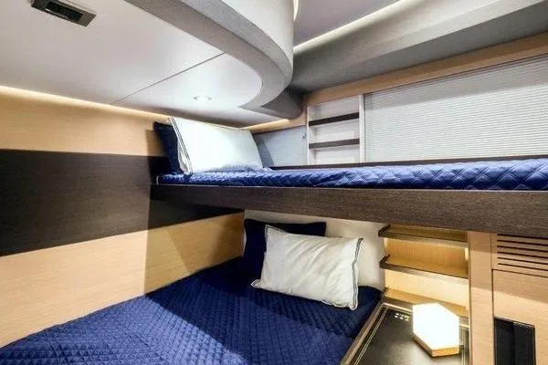 Slide: The Image of Luxurious 2021 OKEAN FB Motor Yacht cabin with modern bunk beds and elegant lighting. - 15