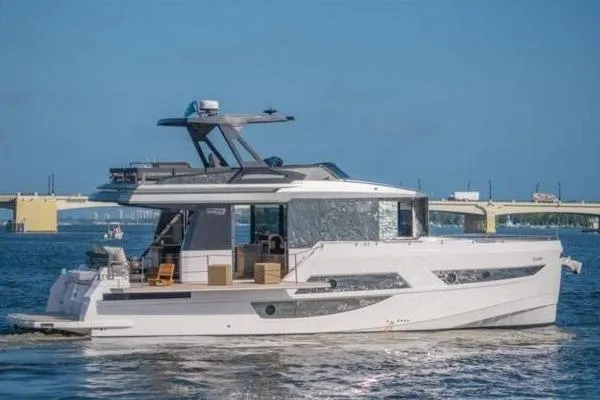 Slide: The Image of 2021 OKEAN FB Motor Yacht cruising on a sunny day near a bridge. - 2